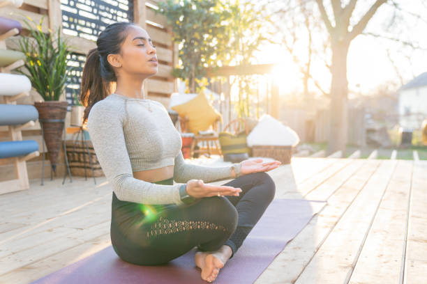 istock Southeast Asian female doing yoga on her deck during sunset 1226478659