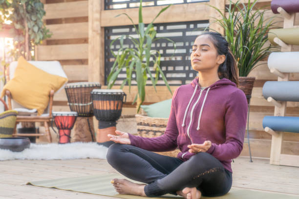 istock Southeast Asian female doing yoga on her deck during sunset 1226478662