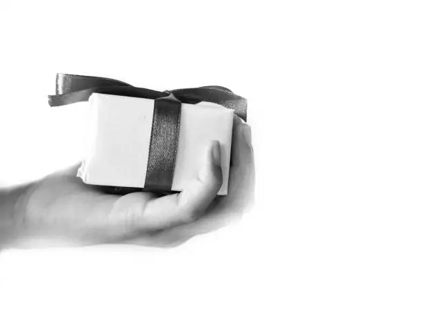 hands holding a red-ribbon gift box