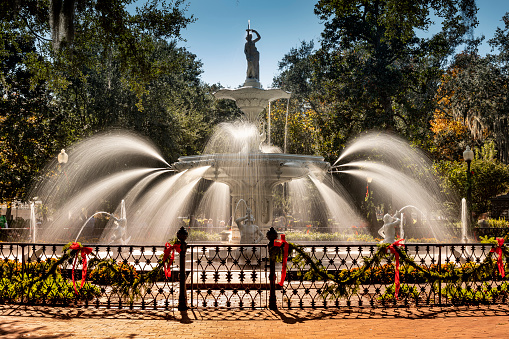 Historic fountain along the foot paths and trees of Forsyth Park in Savannah Georgia USA