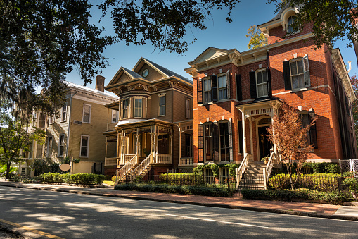 Tree lined historic homes on a residential street in Savannah Georgia USA