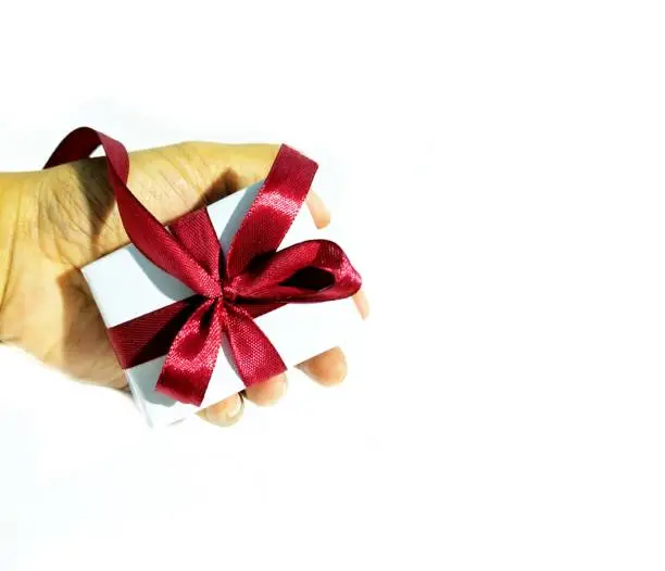 hands holding a red-ribbon gift box