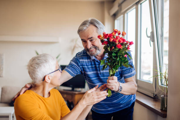 istock Senior woman getting a bouquet from her husband for Valentine's day 1226481068