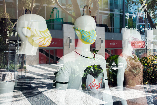 Miami Beach, FL USA - May 21, 2020 - Mannequins with face masks in a retail store window on Lincoln Road Mall.