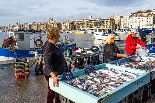 A stall selling fresh fish at the famous Marseille fish market held each morning at the Old Port. Marseille, France, January 2020