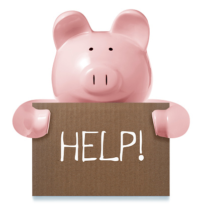 This is a photo of a pink ceramic pig holding a cardboard sign saying Help. The background is a pure white and there is a clipping path included with this file.