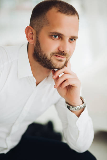 istock Confident man holding chin by hand and looking at camera. 1226486202
