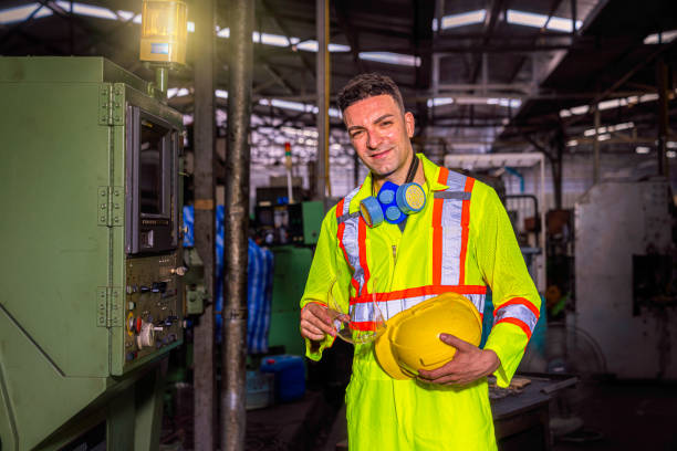 Professional technicians removing hats and masks after working in industrial plants.