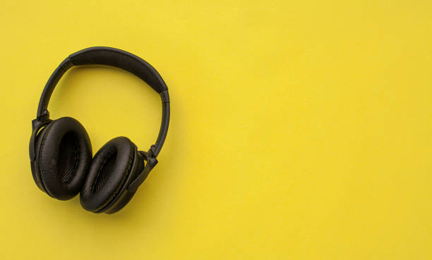 istock Black Headphone In Yellow Backgroung 1226493044