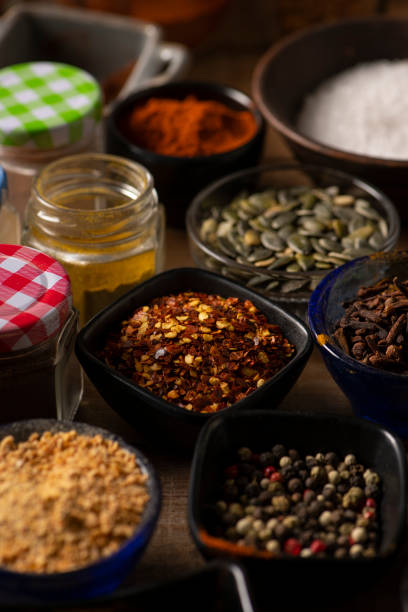 istock Different Spices in small bowls on a wooden table 1226494808