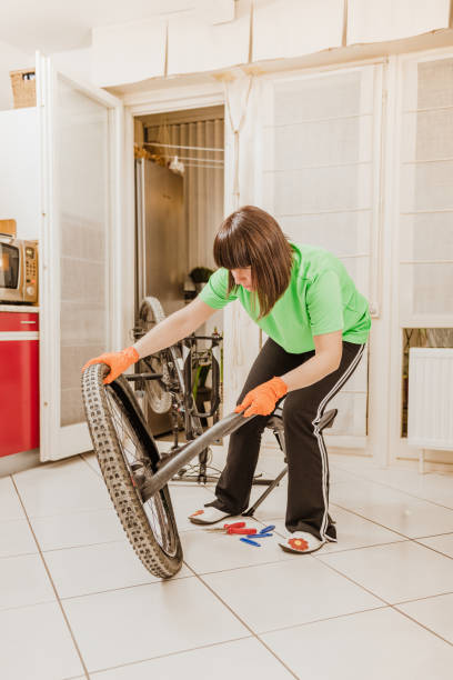 istock woman repairing a flat tire 1226500717