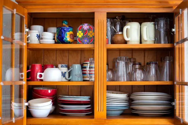 Photo of Crockery in the wooden cupboard