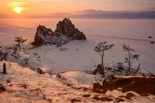 Photo of Sunset view of Shaman rock one of sacred place in frozen lake Baikal in winter season of Siberia, Russia.