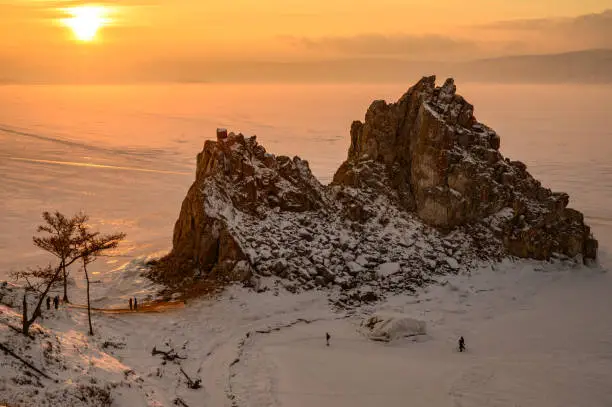 Photo of Sunset view of Shaman rock one of sacred place in frozen lake Baikal in winter season of Siberia, Russia.