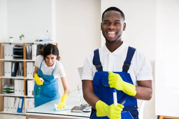 Photo of Happy Male Janitor In Office