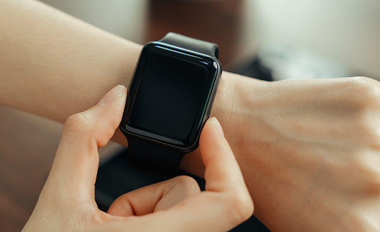 Close-up of female wearing in smart watch application.