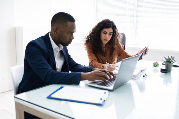 istock Two Businesspeople Calculating Invoice 1226515382