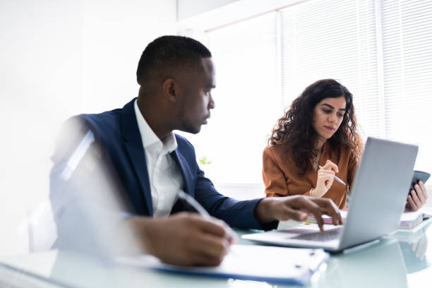 istock Two Businesspeople Calculating Invoice 1226515397