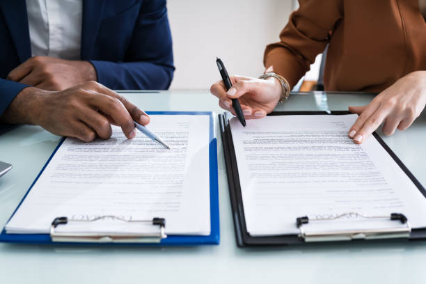 istock Two Businesspeople Working On Contract Paper 1226515428