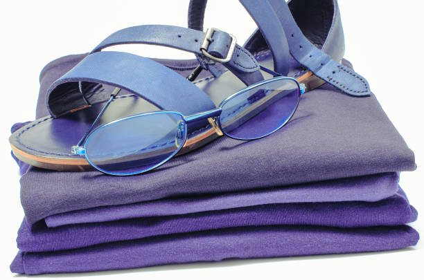 womanly sandals and sunglasses with blue clothes. white background - womanly imagens e fotografias de stock