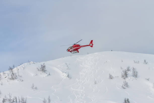istock Red rescue helicopter fly in snowy mountains 1226522619