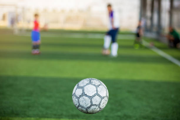 istock Soccer ball bounce with blurry green background 1226525255