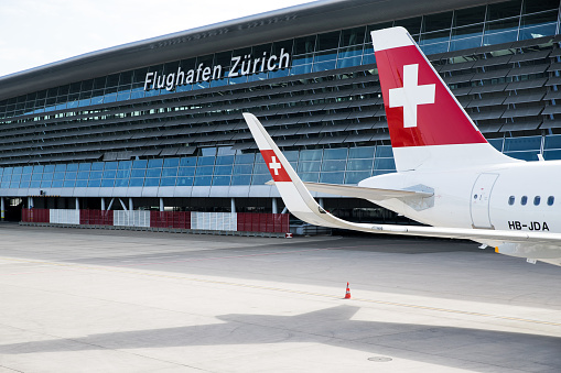 Zurich, Switzerland - May 20, 2020: Overview of Zurich Airport with a Swiss International Air Lines airplane parked at the gate. Zurich Airport is the largest international airport of Switzerland and the principal hub of Swiss International Air Lines.