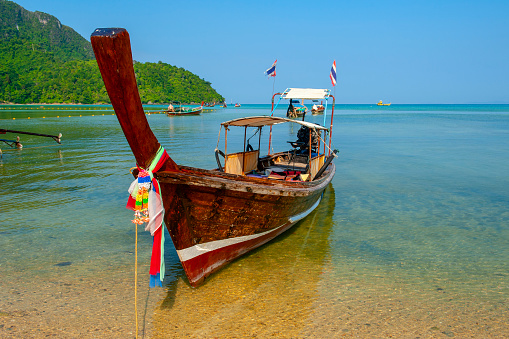 Tropical sea with long tail wooden boat in South Thailand