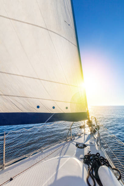 istock Sailing with sun. A view from the yacht's deck to the bow and sails. 1226528330