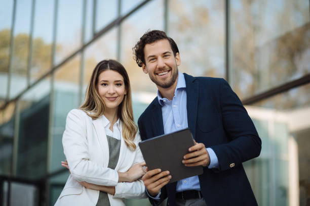 istock Business couple working online outdoors on a tablet computer 1226532396