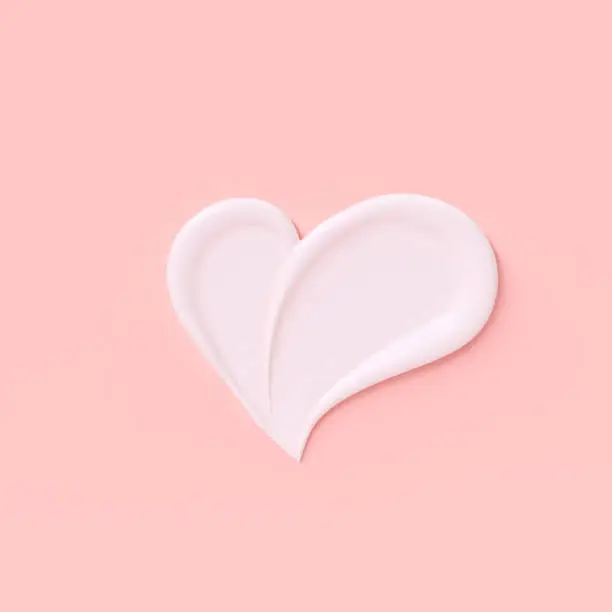 Photo of Love girly background. Cosmetic cream pastel pink and white template banner with heart shape smear. 3d rendering.