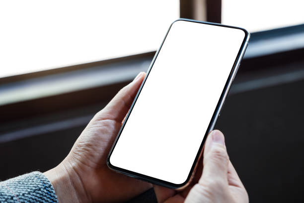 istock a woman holding mobile phone with blank white desktop screen 1226535565