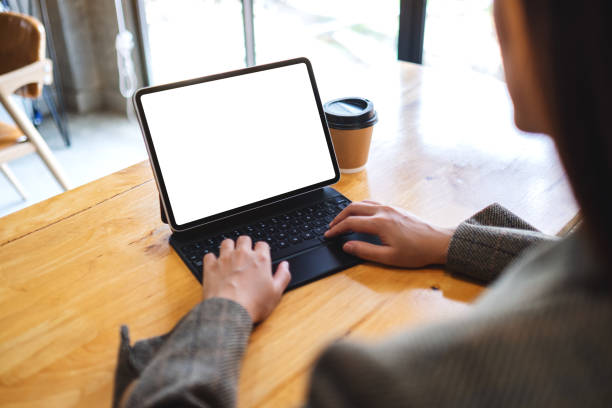 istock a businesswoman using and typing on tablet keyboard with blank white desktop screen as computer pc with coffee cup on the table 1226535602