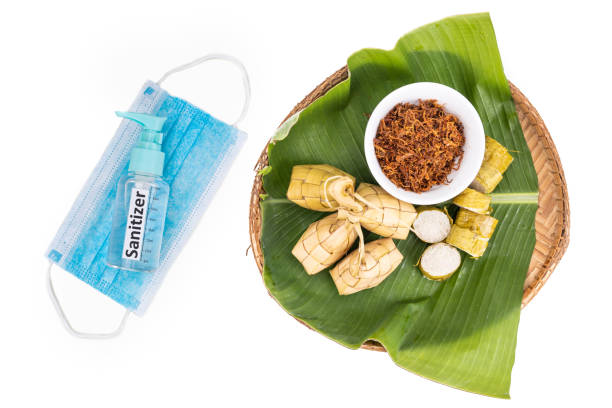 istock Ketupat, rice dumpling, lemang, serunding with sanitizer and face mask. Restricted celebration during covid-19 pandemic 1226540037