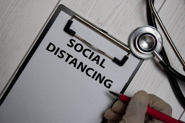 istock Social Distancing write on a paperwork isolated on office desk. 1226544088