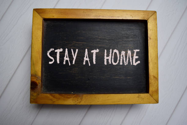 istock Stay At Home write on a chalkboard isolated on office desk. 1226544153