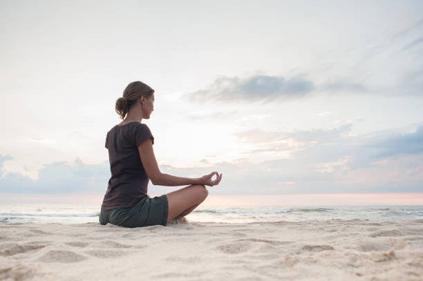 istock Woman is practicing yoga at sunset. Meditation and harmony concept 1226544947