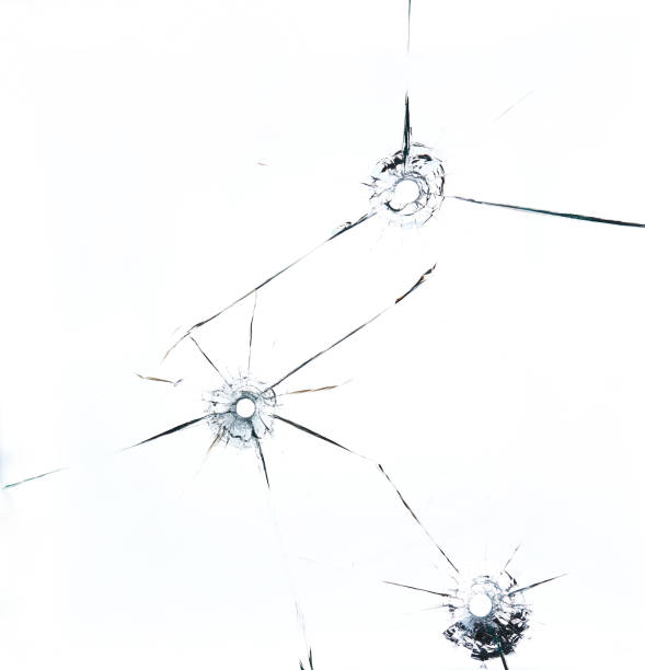 istock three bullet hole in glass close up on white background 1226545137