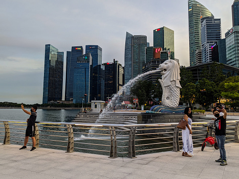 Singapore, Singapore – August 01, 2022: Merlion the signature of Singapore at the merlion park in Holidays with city building and blue sky background