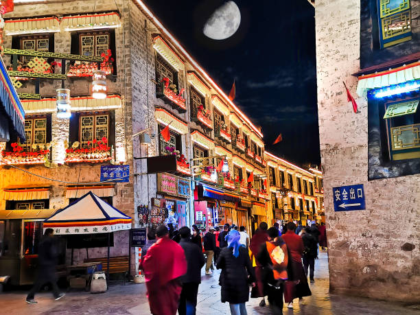 Shopping along the Barkhor Square in Lhasa, Tibet at night. The square is still full of tourist at night.