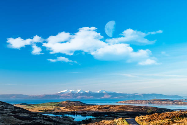 The Arran Hills early mornoing in winter snow capped and a small half moon above in the sky