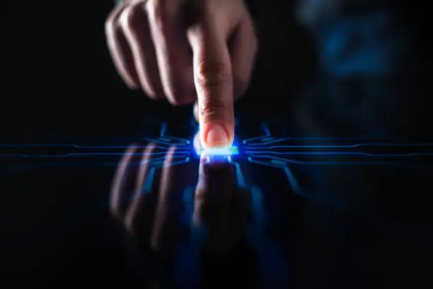Photo of Digitalization Concept: Human Finger Pushes Touch Screen Button and Activates Futuristic Artificial Intelligence. Visualization of Machine Learning, AI, Computer Technology Merge with Humanity