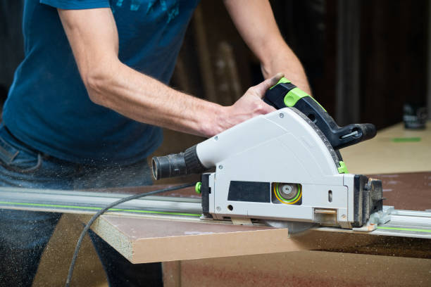istock Carpenter using a disk saw to cut wooden boards. Constructive details of a male worker or a comfortable man with power tools 1226550731