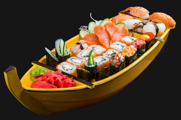 istock Sushi set in a wooden boat on a black background 1226553211