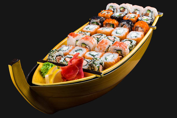 istock Sushi set in a wooden boat on a black background 1226553313
