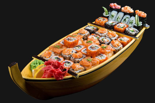 istock Sushi set in a wooden boat on a black background 1226553328