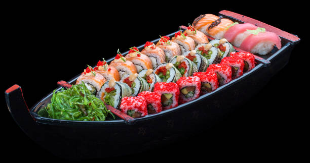 istock Sushi set in a wooden boat on a black background 1226553414