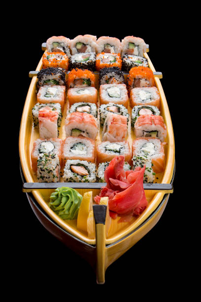 istock Sushi set in a wooden boat on a black background 1226553437