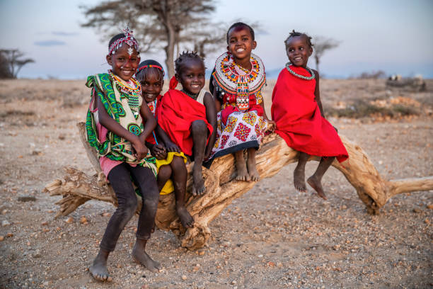 Group of African little children from Samburu tribe, Kenya, Africa Group of happy African little children from Samburu tribe sitting on tree trunk, Kenya, Africa. Samburu tribe is north-central Kenya, and they are related to  the Maasai. african tribal culture photos stock pictures, royalty-free photos & images