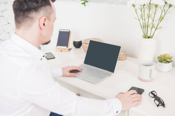 istock Back view of business man using laptop. Freelance or distance study concept 1226554749